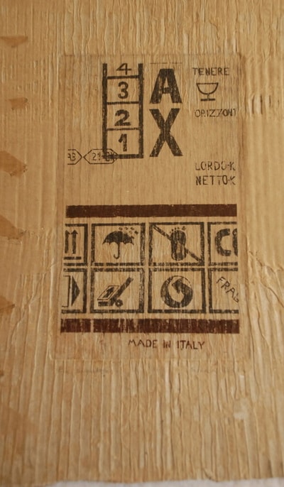 Wooden box shipping label stamped Made in Italy — print on found material by Elisa Sassera